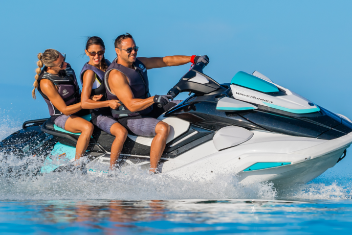 a person riding on the back of a boat in the water